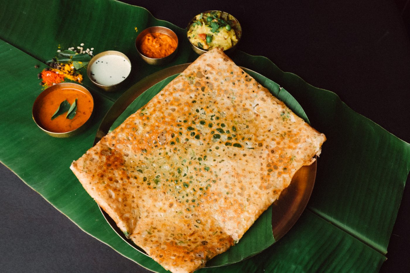Rava dosa served on banana leaf at Anantha Veg World, Mira Road